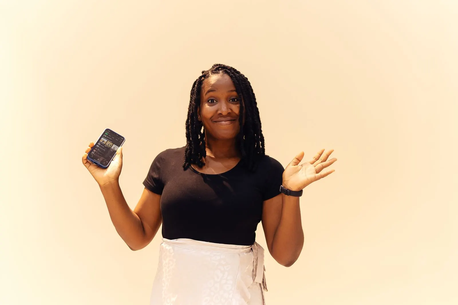 A smiling seller holding her phone